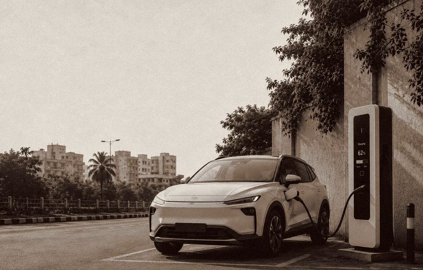 An electric SUV charging at a ChargeIndia station at dusk